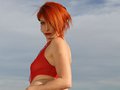 Lyza, the redhead that strips off in red sexy bodysuit on the beach
